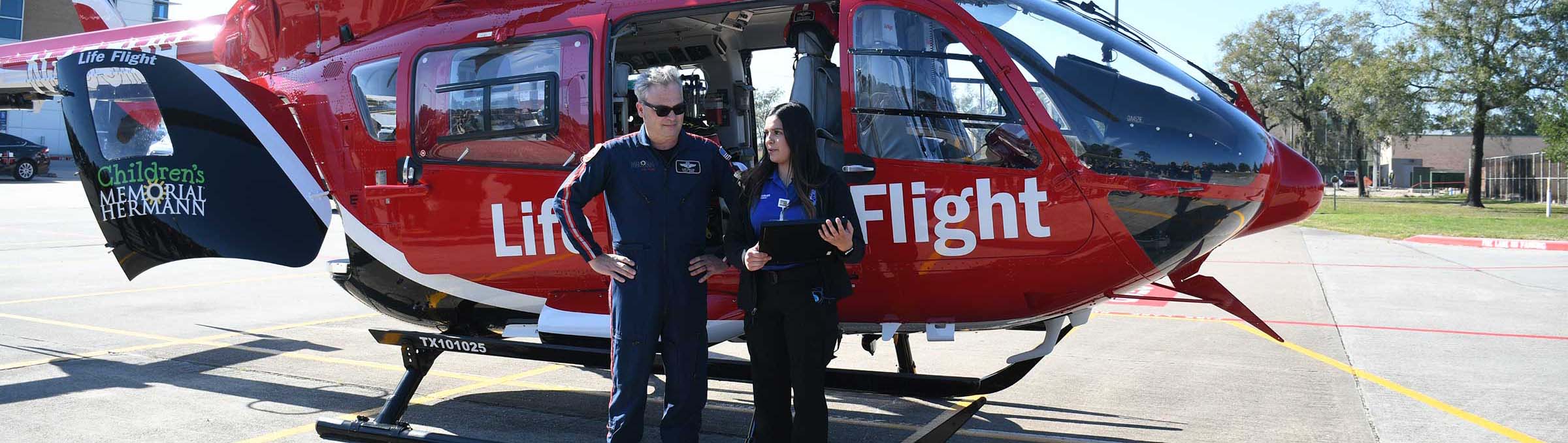 Emergency Medical Services students in front of helicopter