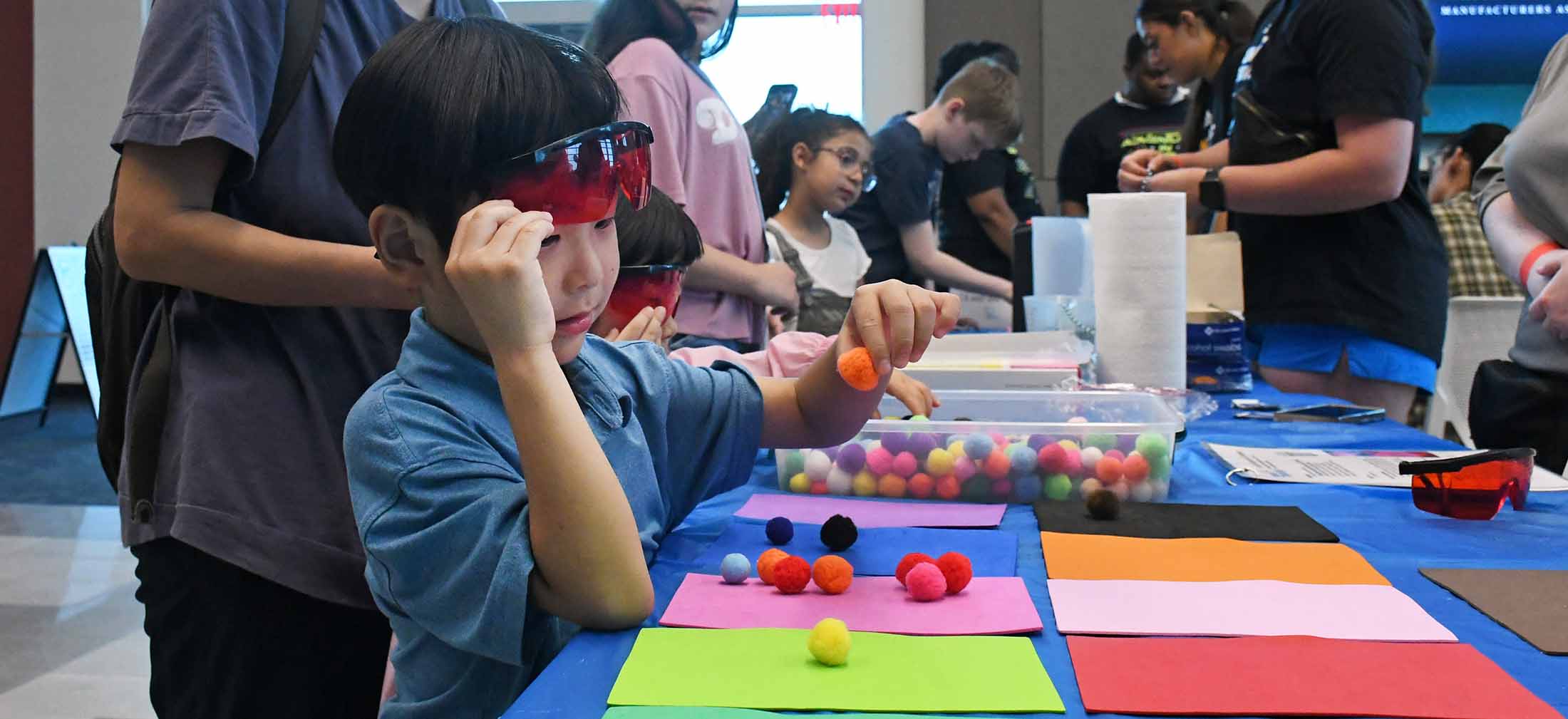 Male Child at Mind Trekkers Event playing with puff balls