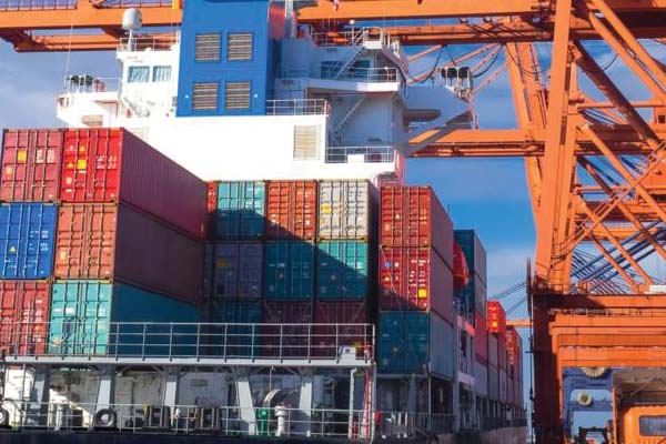 Supply chain shipping barge being unloaded 