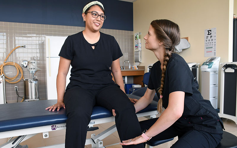 Two San Jacinto College physical therapist assistant students practicing in lab
