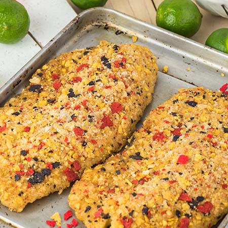 Seasoned cooked tilapia on a baking sheet